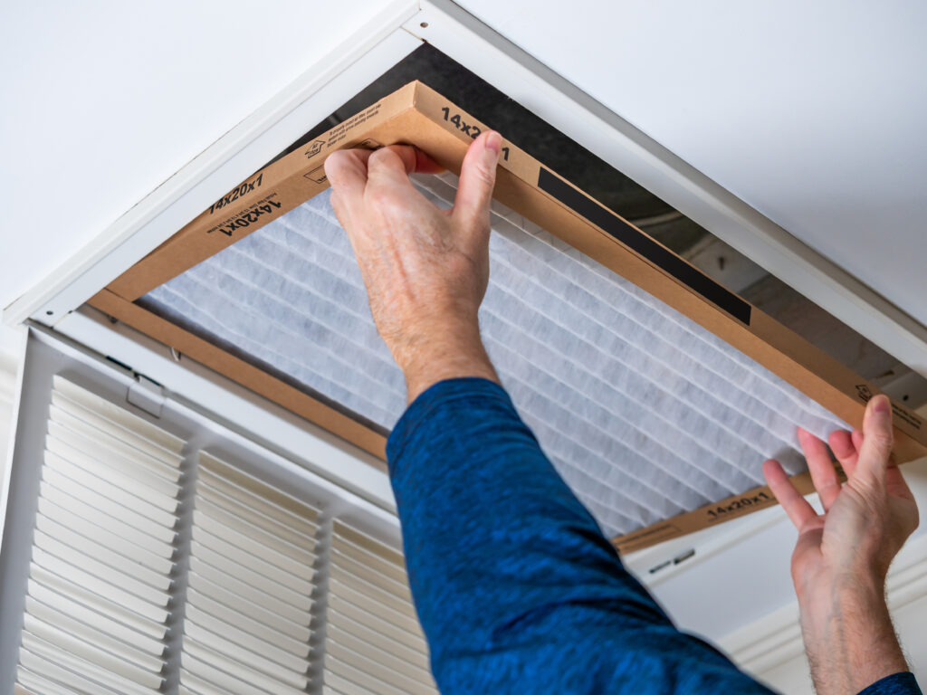 HVAC technician replacing a home air filter in Los Angeles