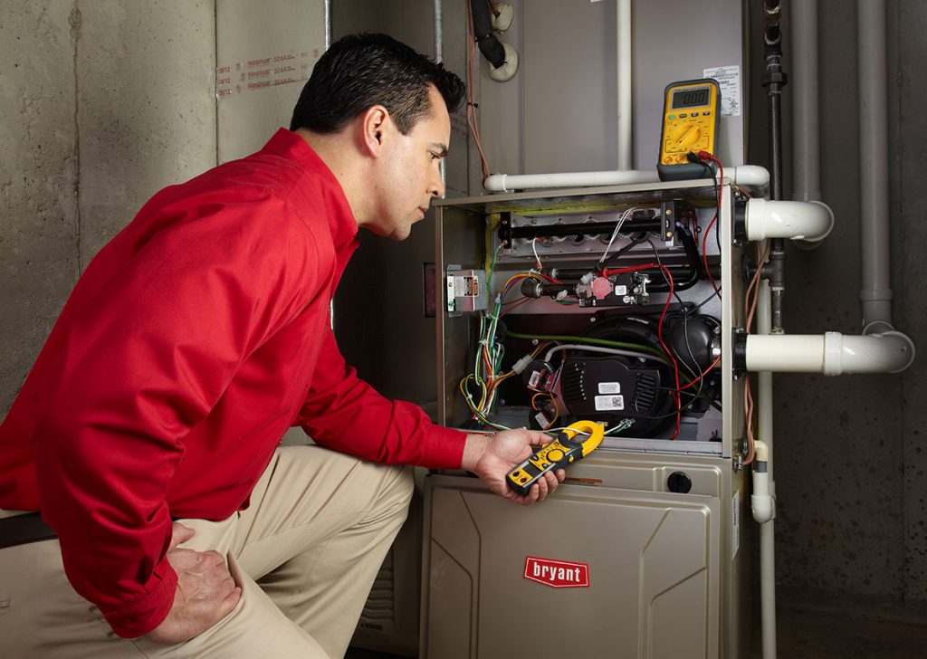 Heating technician diagnosing a furnace repair in Los Angeles