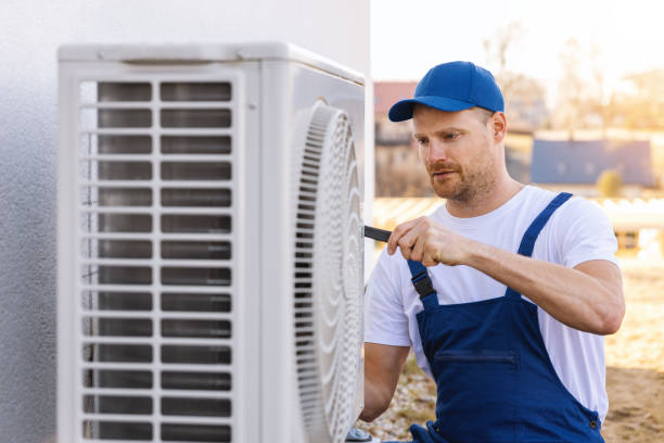 HVAC technician servicing an outdoor air conditioner in Los Angeles